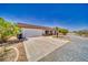 Charming single-story home featuring a two-car garage and desert landscaping at 291 E Hickory St, Pahrump, NV 89048