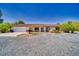 Charming single-story home with desert landscaping, covered porch and two-car garage at 291 E Hickory St, Pahrump, NV 89048