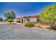 View of the home's front exterior showcasing desert landscaping and a covered porch at 291 E Hickory St, Pahrump, NV 89048