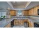 Well-lit kitchen with granite countertops, stainless steel appliances, and light wood cabinets at 291 E Hickory St, Pahrump, NV 89048