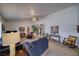 Inviting living room with neutral carpet, ceiling fan and lots of natural light at 291 E Hickory St, Pahrump, NV 89048