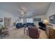 Neutral living room with lots of natural light, ceiling fan, and vaulted ceiling at 291 E Hickory St, Pahrump, NV 89048