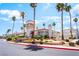Elegant clubhouse with lush landscaping and towering palm trees create a welcoming atmosphere at 3150 Soft Breezes Dr # 1216, Las Vegas, NV 89128