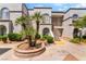 Exterior view of a stucco apartment building with arched windows and well-maintained landscaping at 3150 Soft Breezes Dr # 1216, Las Vegas, NV 89128