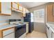 Kitchen features tile floors, plenty of cabinet space, and black appliances at 3150 Soft Breezes Dr # 1216, Las Vegas, NV 89128