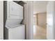 Stacked washer and dryer situated near the bedroom, offering convenience and space-saving design at 3150 Soft Breezes Dr # 1216, Las Vegas, NV 89128