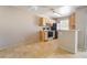 Living room with tile floors and open access to kitchen with breakfast bar at 3150 Soft Breezes Dr # 1216, Las Vegas, NV 89128
