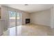 Cozy living room with tile floors, neutral tones, a fireplace and a sliding glass door to a balcony at 3150 Soft Breezes Dr # 1216, Las Vegas, NV 89128