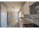 Functional kitchen featuring sleek countertops, a stainless-steel sink, and tiled backsplash at 321 Princess Ave, North Las Vegas, NV 89030