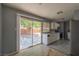 Bright kitchen featuring a sliding glass door leading to the backyard and stainless-steel appliances at 321 Princess Ave, North Las Vegas, NV 89030