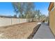 The backyard is fenced with a covered patio, desert landscaping, and a walkway at 3521 Discovery Downs Ct, North Las Vegas, NV 89081
