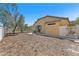 Fenced backyard with desert landscaping, covered patio, and hardscape with gate at 3521 Discovery Downs Ct, North Las Vegas, NV 89081