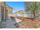 Fenced backyard with desert landscaping, covered patio, hardscape and seating at 3521 Discovery Downs Ct, North Las Vegas, NV 89081
