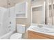 Bright bathroom featuring vanity with sink and shower over tub with white storage at 3521 Discovery Downs Ct, North Las Vegas, NV 89081
