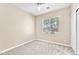 Bright bedroom featuring neutral walls, carpet, a large window, and a closet at 3521 Discovery Downs Ct, North Las Vegas, NV 89081
