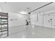 Spacious garage featuring sealed concrete floor, storage rack, and garage door opener at 3521 Discovery Downs Ct, North Las Vegas, NV 89081