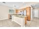 Bright kitchen features granite counters, stainless appliances, and a center island with room for seating at 3521 Discovery Downs Ct, North Las Vegas, NV 89081