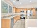 Bright kitchen features granite counters, stainless appliances, and a center island with room for seating at 3521 Discovery Downs Ct, North Las Vegas, NV 89081