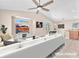 Spacious living room with tile flooring, a ceiling fan, and a view to the backyard at 3521 Discovery Downs Ct, North Las Vegas, NV 89081