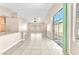 Bright open-concept living space with tile flooring, neutral paint, and sliding glass doors at 3521 Discovery Downs Ct, North Las Vegas, NV 89081