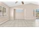 Spacious and empty living space featuring tile floors and large windows with natural light at 3521 Discovery Downs Ct, North Las Vegas, NV 89081