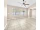 Spacious and bright living space featuring tile floors, large windows and a ceiling fan at 3521 Discovery Downs Ct, North Las Vegas, NV 89081