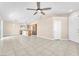 Open living space with tile floors connecting the living room, dining area, and kitchen at 3521 Discovery Downs Ct, North Las Vegas, NV 89081