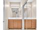 This bathroom is equipped with a double vanity and mirrors, and closet with mirrored doors at 3521 Discovery Downs Ct, North Las Vegas, NV 89081