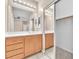 This bathroom is equipped with a double vanity and mirrors, and closet with mirrored doors at 3521 Discovery Downs Ct, North Las Vegas, NV 89081