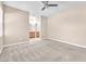 This is a spacious main bedroom with neutral carpet and a ceiling fan, next to the main bathroom at 3521 Discovery Downs Ct, North Las Vegas, NV 89081