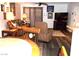 Living room featuring hardwood floors, leather furniture, ceiling fan and decorative artwork at 3720 Desert Marina Dr # 33, Laughlin, NV 89029