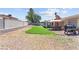 Landscaped backyard featuring an artificial turf lawn, patio area, and ample space for activities at 421 Carlin Ave, Las Vegas, NV 89110