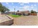 Large backyard featuring a landscaped area, patio seating, and plenty of open space at 421 Carlin Ave, Las Vegas, NV 89110