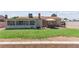 Well-maintained backyard featuring a patio, artificial turf, gravel landscaping, and privacy fencing at 421 Carlin Ave, Las Vegas, NV 89110