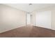 This bedroom has neutral walls, carpet flooring, and closet storage at 421 Carlin Ave, Las Vegas, NV 89110