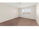 This bedroom has neutral walls, carpet flooring, and a window providing natural light at 421 Carlin Ave, Las Vegas, NV 89110