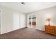 This bedroom has neutral walls, carpet flooring, and sliding door access to the sunroom at 421 Carlin Ave, Las Vegas, NV 89110