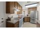 This kitchen features wood cabinets, stainless steel refrigerator, and white appliances at 421 Carlin Ave, Las Vegas, NV 89110