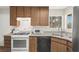 This kitchen features wood cabinets, stainless steel sink, and white appliances at 421 Carlin Ave, Las Vegas, NV 89110