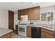 Cozy kitchen featuring classic cabinetry, stainless steel appliances, and a bright window above the sink at 421 Carlin Ave, Las Vegas, NV 89110