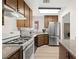 This kitchen features wood cabinets, stainless steel refrigerator, and white appliances at 421 Carlin Ave, Las Vegas, NV 89110