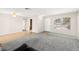 Open living room featuring neutral walls, a large window, and access to the kitchen area at 421 Carlin Ave, Las Vegas, NV 89110
