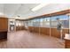 Spacious sunroom featuring wood-look flooring, paneled walls, and multiple windows for ample natural light at 421 Carlin Ave, Las Vegas, NV 89110