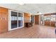 Bright sunroom featuring wood-look flooring, paneled walls, and sliding glass doors for indoor-outdoor living at 421 Carlin Ave, Las Vegas, NV 89110