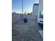 Gravel backyard featuring brick fencing, fire pit, and desert landscaping at 4363 Pittsfield St, Las Vegas, NV 89115