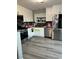 Bright kitchen with stainless steel appliances, white cabinets, and hardwood floors at 4363 Pittsfield St, Las Vegas, NV 89115