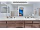 Bathroom featuring double sinks, large mirror, and great lighting at 452 Waterwheel Falls Dr, Henderson, NV 89015