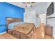 Spacious bedroom featuring a king-size bed, blue accent wall, and modern fixtures at 452 Waterwheel Falls Dr, Henderson, NV 89015