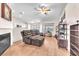 Cozy living room with a fireplace, comfortable seating, and bright natural light at 452 Waterwheel Falls Dr, Henderson, NV 89015
