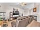 Spacious living room featuring a fireplace, ceiling fan, and comfortable leather furniture at 452 Waterwheel Falls Dr, Henderson, NV 89015